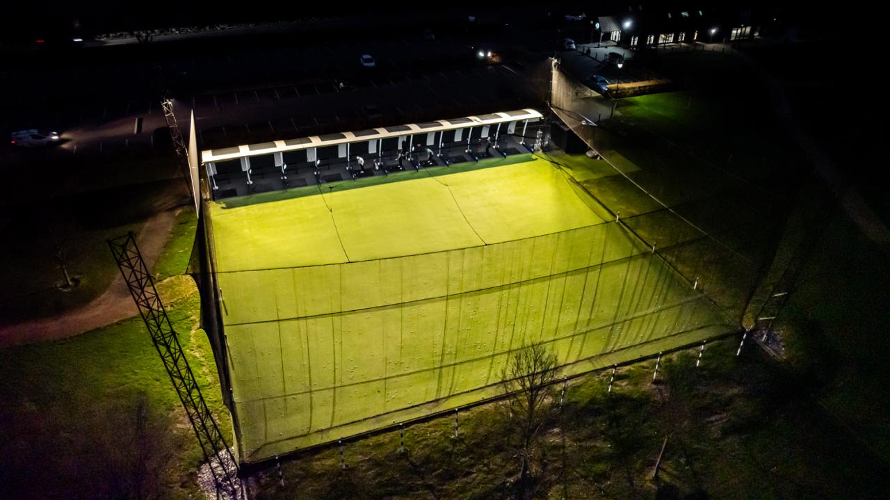 Golf Pod driving range illuminated at night, viewed from above