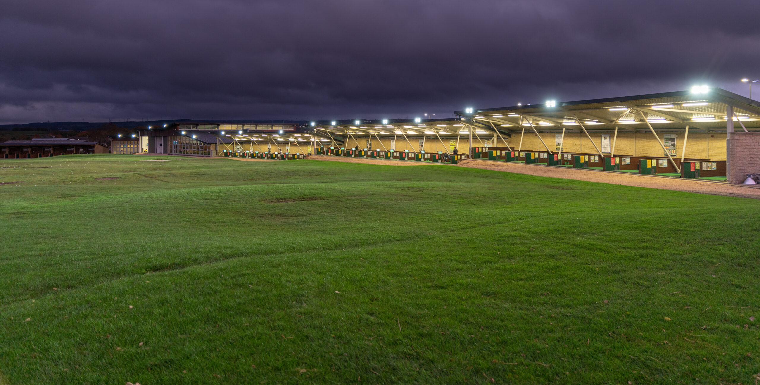 Mearns Castle Golf Academy driving range illuminated at night